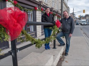 Florists Julie Docker Johnson and Lanny Hoare have for the second year decorated downtown St. Marys with hundreds of bows and garland ahead of the annual Merchants’ Open House this weekend. Chris MontaniniStratford Beacon Herald/Postmedia News