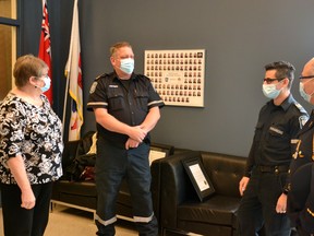 Perth County Paramedic Services commander Mike Grosz (right) and his wife Evelyn Grosz (left) chat with the two paramedics who saved Mike Grosz’s life -- Randy Bonsma and Samer Sayegh -- when he suffered a heart attack and subsequent cardiac arrest at his home in Listowel in September. Bonsma and Sayegh were at the Perth County Paramedic Services headquarters in Stratford Thursday to receive commendations from Perth County council for the actions they took to save their colleague’s life. Galen Simmons/The Beacon Herald/Postmedia Network