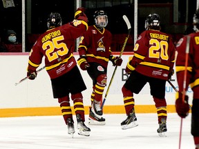Timmins Rock forward Dylan McElhinny celebrates his first-period goal with teammates, from left, Bode Dunford, Christopher Engelbert and Cameron Dutkiewicz during Sunday afternoon’s NOJHL game at the McIntyre Arena. McElhinny’s goal staked the Rock to a 1-0 lead in a game they would go on to win 5-2. McElhinny was ejected from the contest late in the third period after being assessed a five-minute major for head contact and a game misconduct. THOMAS PERRY/THE DAILY PRESS