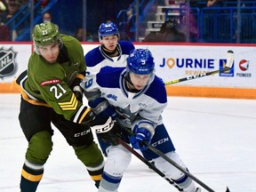 Brandon Coe of the North Bay Battalion battles Alex Assadourian of the Sudbury Wolves. Coe has been named Player of the Week.
Sean Ryan Photo