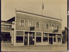 •	1982.1215.002 – The McNamara Hotel and Palace of Eats café and meat market, possibly P. Burns & Co., left of photograph on Peace River Main Street as they were circa 1920s-1930s. Standing in front of the Mac – Martin McNamara (l) and unidentified man, possibly William Kalampusis, known to all as Bill the Greek, owner Palace of Eats – died June 4, 1947. Note the wooden sidewalk.