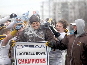 Korah Colts head coach Tom Annett gets a cold water shower following his team’s 35-7 win over the St. Ignatius Falcons in the Northern Bowl at Superior Heights on Saturday afternoon. Annett talked about a first half goalline stand that was a contributing factor in the Colts’ victory at Sergeant John Faught Fieldhouse.