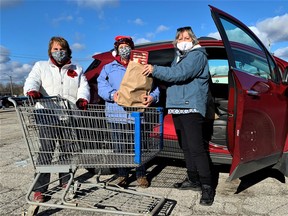 For a second year running, there was strong community support for the Drive-Thru Food Drive at the Norfolk County Fairgrounds. Among those helping fight hunger and want in Norfolk on Tuesday were, from left, volunteer Gail Catherwood of Simcoe, Wendy Brick of the Norfolk County Fair, and donor Kate VanBradt of Simcoe. – Monte Sonnenberg
