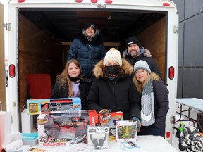 Rotary Club members and Oil Wives, including (back) Candace Laprise and Marcel LeCoure, and (front, l-r) Prentice LeCoure, Fay Arcand and Alana Bruce, joined a toy drive to support the Christmas Hamper Saturday, outside the Canadian Tire parking lot.