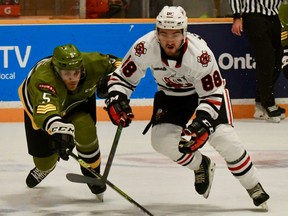 Tnias Mathurin of the host North Bay Battalion competes for the puck with Liam Van Loon of the Niagara IceDogs in the Troops' 7-3 Ontario Hockey League victory Sunday. The Troops open a road swing against the Peterborough Petes on Thursday night.
Sean Ryan Photo