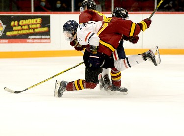 Timmins Rock blue-liner Chase Longhurst catches French River Rapids forward Chase Lefebvre with a hip check during the first period of Friday night’s NOJHL contest at the McIntyre Arena. The Rock built up a three-goal lead and then hung on to edge the Rapids 3-2, grabbing a share of top spot in the NOJHL’s overall and East Division standings in the process. THOMAS PERRY/THE DAILY PRESS