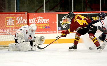 Timmins Rock captain Tyler Schwindt gets off a shot on French River Rapids goalie Cole Sheffield despite being harassed by blue-liner Adam Boucher during the second period of Friday night’s NOJHL contest at the McIntyre Arena. Sheffield made the save on this play, but Schwindt scored what would prove to be the game-winning goal later in the period as the Rock held on to defeat the Rapids 3-2. THOMAS PERRY/THE DAILY PRESS