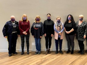 Members of the Leduc and District Family Violence Prevention Team gather prior to a training session Nov. 17 at the Coast Nisku Inn. All members are shown wearing purple face masks. (Leduc and District Family Violence Prevention Team)
