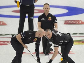 Skip Brad Jacobs of Sault Ste.Marie follows his front end (L-R) lead Ryan Harnden, 2nd. E.J.Harnden during draw 16 against Team McEwen on Friday morning. The Jacobs rink clinched a semifinal berth with a 9-5 win over McEwen at the Canadian Olympic Curling Trials in Saskatoon.