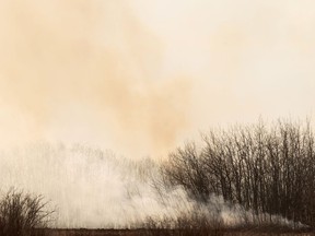 A grass fire on a homestead near Lamont, north of Edmonton, on Friday, April 16, 2021. PHOTO BY IAN KUCERAK /Postmedia
