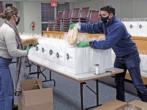 Sierra Mercer and Nico Waltenbury load loaves of fresh bread into Bay Bundles just before Christmas last year. 
Nugget File Photo