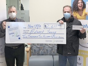 Edward Young, right, took home $2,611 as the week #17 winner of the Pembroke Regional Hospital Foundation's (PRHF) Catch the Ace 3.0 progressive jackpot lottery. He is presented with his prize in the photo by Roger Martin, PRHF executive director. Submitted photo