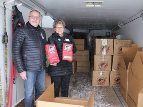 Ron and Denise Kruger stand inside a trailer in the Peace Lutheran Church parking lot that was being filled with shoeboxes collected during the annual Operation Christmas Child program. (Ted Murphy)