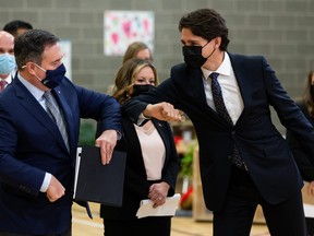 Prime Minister Justin Trudeau (right) and Alberta Prmier Jason Kenney bump elbows during a joint federal-provincial announcement of $10-a-day daycare at Boyle Street Plaza in Edmonton, on Monday, Nov. 15, 2021. Photo by Ian Kucerak