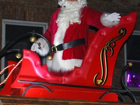 Kris Kringle waves to children along the route of the 76th annual Kiwanis Owen Sound Santa Claus parade Saturday evening. DENIS LANGLOIS