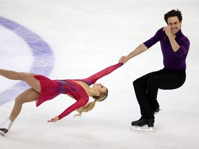 Canada's Kirsten Moore-Towers and Michael Marinaro compete in the pairs' short program during the Rostelecom Cup on the 2021 ISU Grand Prix of Figure Skating circuit in Sochi, Russia, on November 26, 2021. (Photo by DIMITAR DILKOFF/AFP via Getty Images)