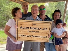 The Chatham Tennis Club has renamed its clubhouse to honour longtime volunteer Aldo Gonzalez. He's pictured with family members at a plaque presentation ceremony. (Contributed Photo)