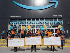 Representatives of the Boys and Girls Club of Leduc, the Riseup Society and the Leduc Hub Association display the cheques they received from Amazon. (Boys and Girls Club of Leduc)