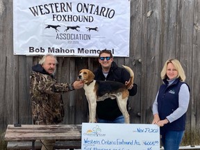 More than $6,000 was raised by the Western Ontaro Foxhound Association's annual field trial for Residential Hospice of Grey Bruce in August. From the left, Don Bannerman, Dave Smith with his field trial-winning Walker Foxhound Saugeen Yo-Yo, and Amy McConachie from the hospice, on Saturday, Nov. 27, 2021 in Elmwood, Ont. (Residential Hospice of Grey Bruce photo)