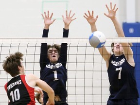 Ursuline Lancers' Carter Pittuck (1) and Alex Chickowski (7) block Northern Vikings' Preston Archer (10) during an LKSSAA senior boys' volleyball AAA semifinal at Ursuline College Chatham in Chatham, Ont., on Tuesday, Nov. 9, 2021. Mark Malone/Chatham Daily News/Postmedia Network