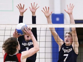 Ursuline Lancers' Carter Pittuck (1) and Alex Chickowski (7) try to block Northern Vikings' Turner Jenkins (13) during an LKSSAA senior boys' volleyball AAA semifinal at Ursuline College Chatham in Chatham, Ont., on Tuesday, Nov. 9, 2021. Mark Malone/Chatham Daily News/Postmedia Network