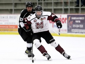 Chatham Maroons' Warren Clark (44) battles Komoka Kings' Alex MacLeod (22) for the puck in the second period at Chatham Memorial Arena in Chatham, Ont., on Sunday, Nov. 14, 2021. Mark Malone/Chatham Daily News/Postmedia Network