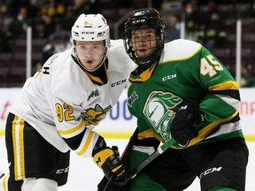 London Knights' Gerard Keane, right, checks Sarnia Sting's Nikita Tarasevich in the first period at Progressive Auto Sales Arena in Sarnia, Ont., on Tuesday, Nov. 16, 2021. Mark Malone/Chatham Daily News/Postmedia Network