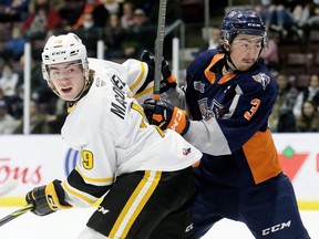 Sarnia Sting's Angus MacDonell, left, battles Flint Firebirds' Luca D'Amato (3) in the first period at Progressive Auto Sales Arena in Sarnia, Ont., on Friday, Nov. 26, 2021. Mark Malone/Chatham Daily News/Postmedia Network