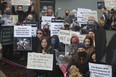 Protestors gather in front of the farm owner’s vet clinic