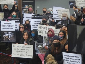 Protestors gather in front of the farm owner’s vet clinic