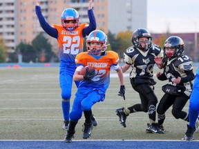 Cole Switzer (32) of the Sarnia U12 Sturgeon scores a touchdown as Colby Jacklin (22) celebrates during an Ontario Fall Football League game. The U12 Sturgeon are 2021 league champions and Football Ontario Fall Cup finalists. (Rick Schroeter/SilverPeak Studios of Canada)