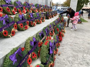 After the Remembrance Day services at the Paris cenotaph, Amy Geddes helped her daughter, Lilly, place a wooden cross on a wreath honouring the wartime service of her relatives.