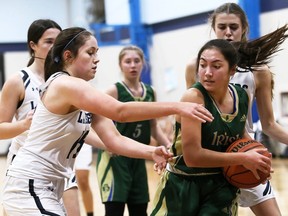 Aliyah Shaw, right, of the St. Patrick's Fighting Irish grabs a rebound away from Ursuline Lancers' Elliot Cowan during the LKSSAA senior girls' basketball AAA championship at Ursuline College Chatham in Chatham, Ont., on Thursday, Nov. 18, 2021. Mark Malone/Chatham Daily News/Postmedia Network