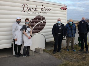 Const. Cheri-Lee Smith and Sgt. Shane Himmelman of the Leduc RCMP are shown with resident Bill Adair along with Dark Kiss Coffee owner Diana Bier and barista Meghan Lacey. (Ted Murphy)