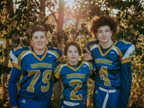 Stony Plain Bombers Caden Fearon (centre), Kohen Sheppard (right), and Angus Ulmer (left) have each been awarded the 'Iron Bomber' award for being longstanding members of the club. Photo by Connie McNeice/BeautiFlow Photography.