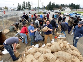 Community members fill thousands of sandbags at a volunteer-led event in Abbottsford, British Columbia on November 20, 2021.  REUTERS/Jennifer Gauthier