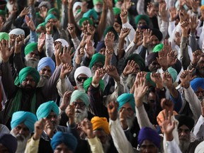 People gather on the eve of the first anniversary of farmers' protests on the outskirts of Delhi at Tikri border, India, November 25, 2021. REUTERS/Anushree Fadnavis