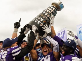 Western Mustangs players cheer after beating the Queen's Gaels 29-0 to win the Yates Cup for the Ontario University Athletics football championship on Saturday at Richardson Stadium.