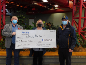 Harold Wilson (left) and Gerald Thomas (right) of the Rotary Club of Nisku-Leduc presented Cash for a Cause 50-50 draw winner Brenda Reimer with a cheque for $40,000. (Rotary Club of Nisku-Leduc)