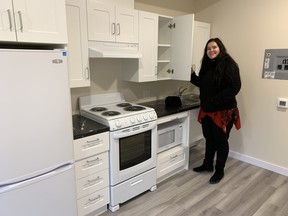 Deb Schlichter, Brantford's acting director of housing and homelessness services, show off the accessible kitchen in one of the four new small housing units completed on Stirton Avenue. It is the first of the city and county's push to build affordable homes.