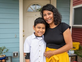 Lizet Molina Neri and her son, Alan (9), in front of the Habitat home that she helped build.
