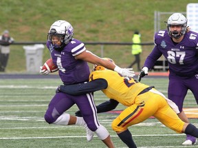 Western Mustangs Trey Humes tries to get past Queen's Gaels Eric Colonna during the Yates Cup at Richardson Stadium in Kingston on Saturday November 20, 2021. Ian MacAlpine/Kingston Whig-Standard/Postmedia Network
