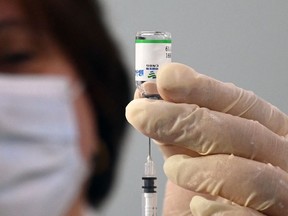 A healthcare worker prepares a dose of vaccine against Covid-19