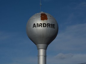 The water tower stands with paint peeling above the "Airdrie" logo. The City of Airdrie is applying to designate the tower as a historical resource, which could open grant funding opportunities for its repair.