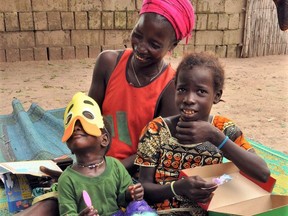 Children in Senegal checking out the contents of their Canadian-packed Operation Christmas Child shoeboxes. Photo submitted by Frank King.