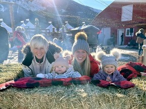 (Left-right) Chris, Brodie, Spencer and Grayce MacDonald enjoy the Banff Christmas Market at Warner Stables on Nov. 19. 2021. Over 80 artisan vendors, live music, an outdoor fire lounge, Santa's House and Reindeer Stables, Christmas treats and warm drinks got the Christmas spirit going, and rekindled the market tradition in Banff. Photo Marie Conboy/ Postmedia.