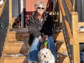 Meg Nicks and her puppy Pippin enjoy a sunny day in Canmore. Nicks owned Sunny Raven Gallery in Canmore for over 30 years. photo by Pam Doyle/www.pamdoylephoto.com