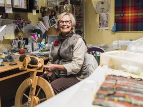 Colleen Thomson, past President of the Belleville Weavers & Spinners Guild, spins yarn on a spinning wheel in her fiber arts studio in the basement of her home. Wednesday in Belleville, Ontario. ALEX FILIPE