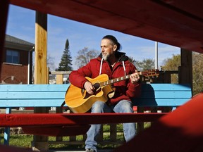 Cooper resident Terri Clancy plays guitar Friday morning in a gazebo near the Madoc Public Library. He owns the guitar but enjoys borrowing many other instruments from the Stirling Musical Instrument Lending Library, of which the Madoc library is a satellite location.