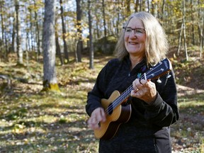 Deb Chatreau plays a ukulele outside her Tweed-area home. The retired elementary school teacher will lead an online ukulele course for seniors through Music Link, a project of the Stirling Musical Instrument Lending Library.